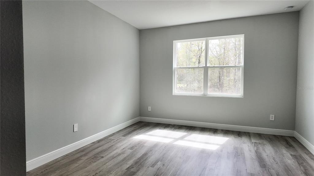 7 Spring Pass Ocala, FL 34472 - Photo 18 of 35 an empty room with wooden floor and windows