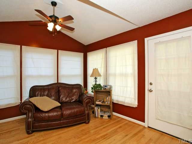 2308 Florida Court Raleigh, NC 27615 - Photo 6 of 12 a living room with furniture a ceiling fan and a large window