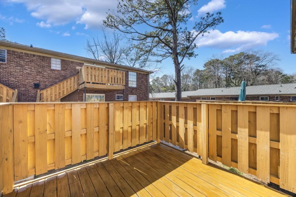 5629 Kingsport Drive, Unit 11 Atlanta, GA 30342 - Photo 26 of 52 a front view of a house with a wooden fence