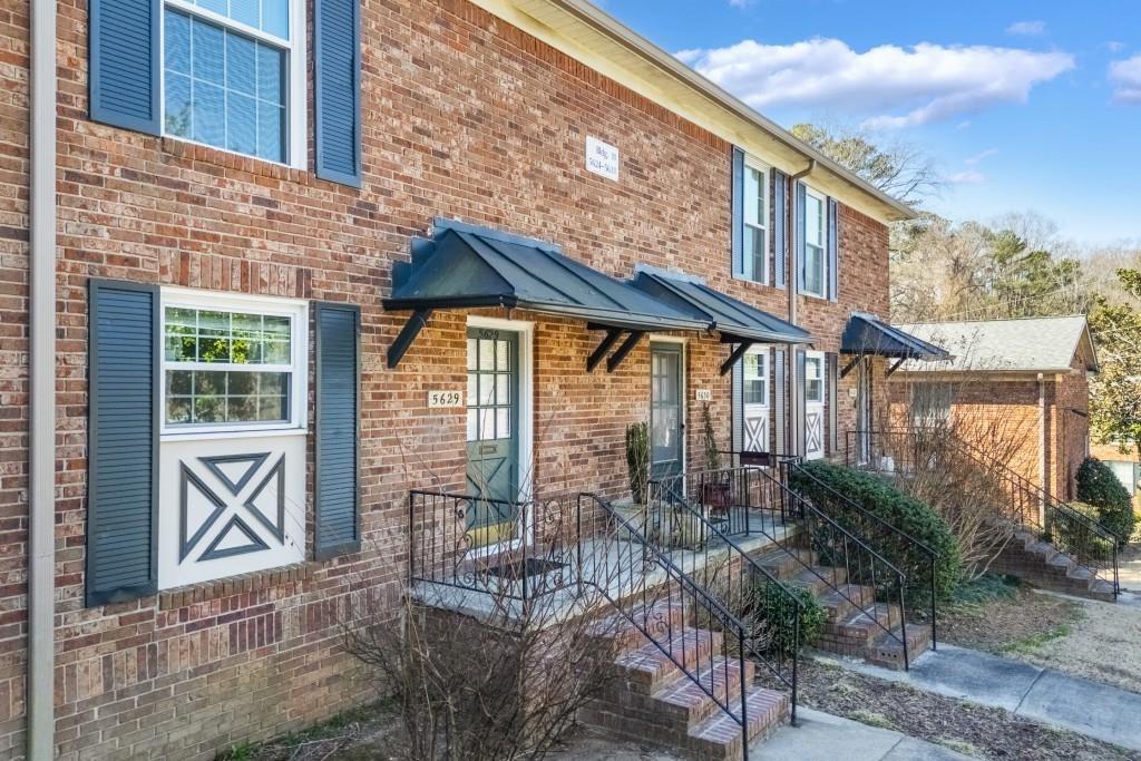 5629 Kingsport Drive, Unit 11 Atlanta, GA 30342 - Photo 33 of 52 a front view of a house with a glass door and glass windows