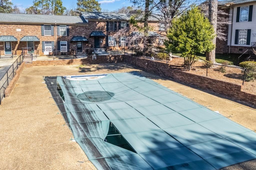 5629 Kingsport Drive, Unit 11 Atlanta, GA 30342 - Photo 35 of 52 a view of a swimming pool with a patio