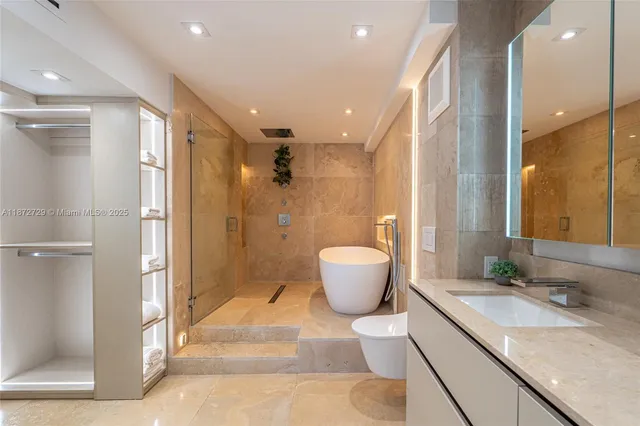 a bathroom with a granite countertop sink a toilet a mirror and shower