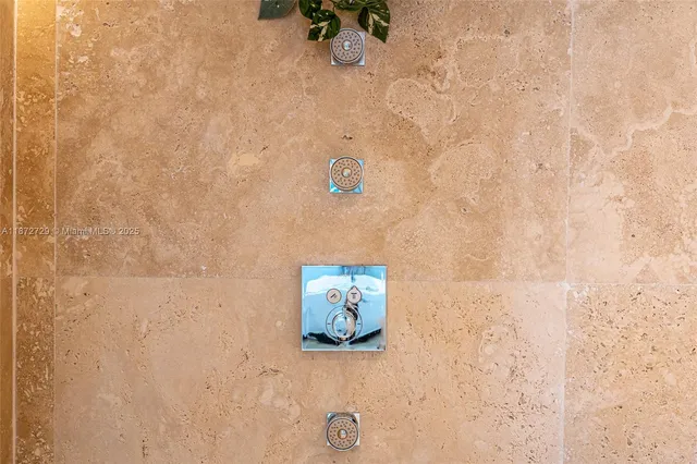 a bedroom with a large bed and chandelier