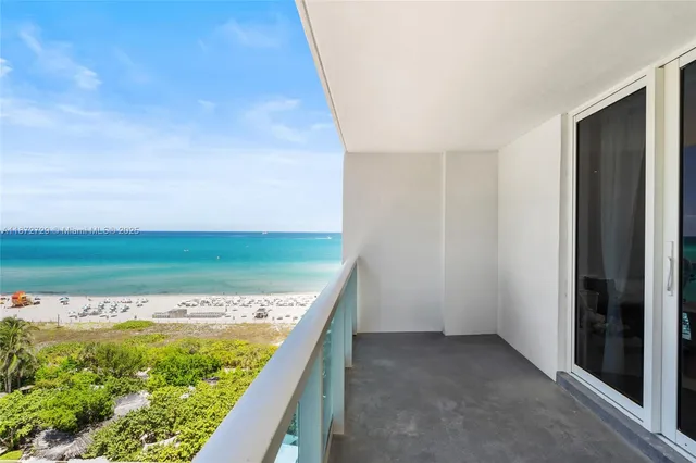 a room with wooden floor pool table and chairs