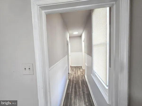 a view of a room with wooden floor and a window