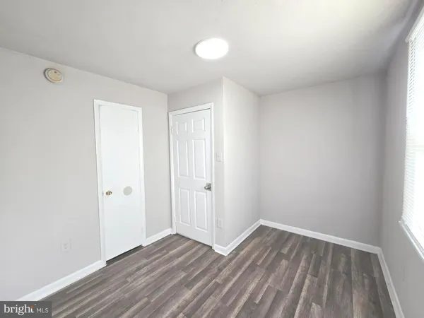 a view of an empty room and wooden floor