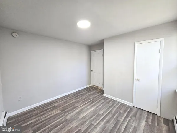 a view of room with wooden floor