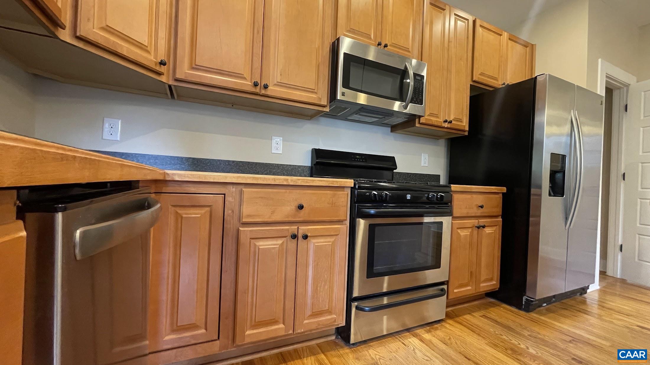 200 Harris Road Charlottesville, VA 22903 - Photo 14 of 28 a kitchen with stainless steel appliances granite countertop a refrigerator microwave and sink