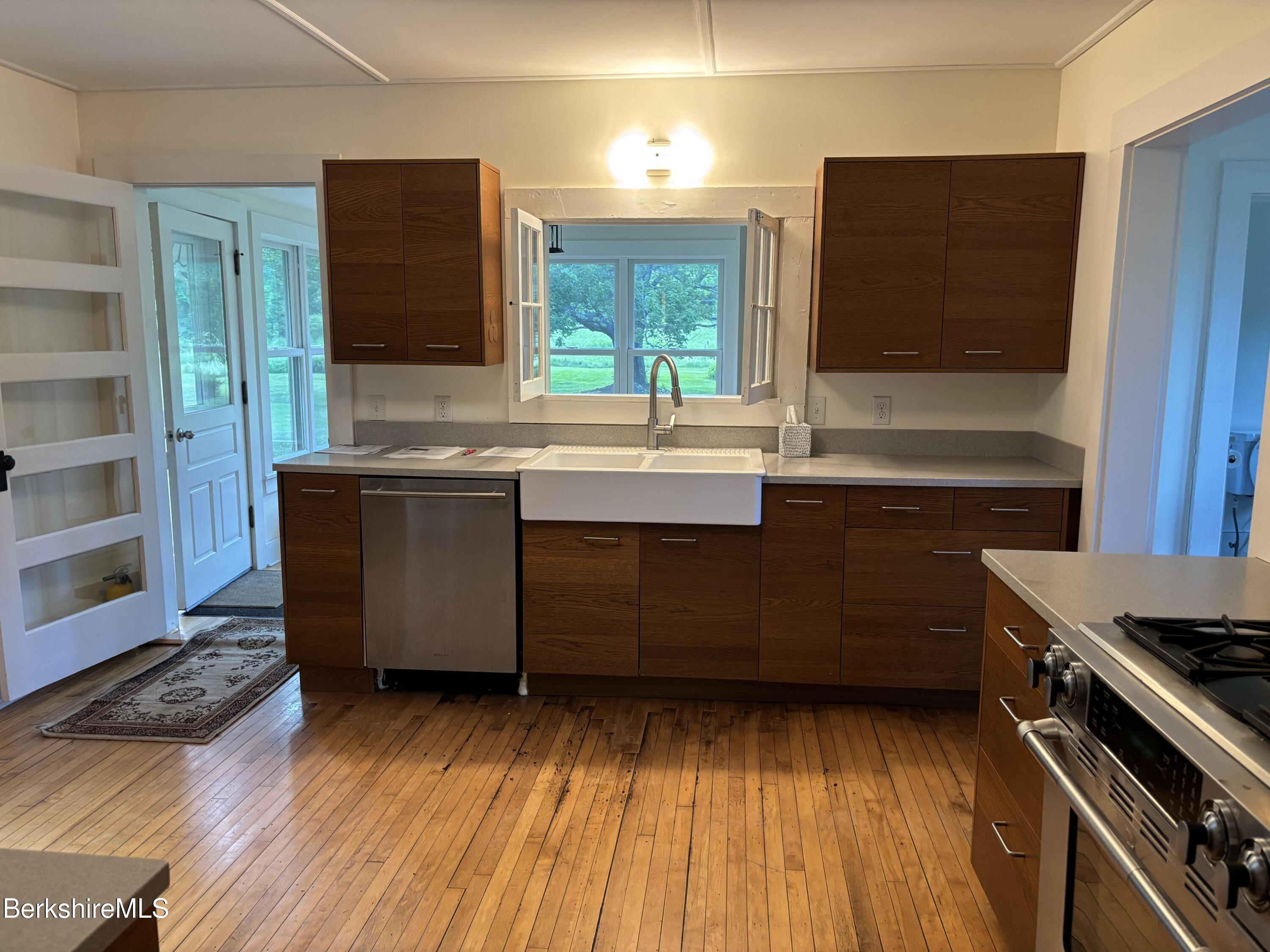 86 Miner Road Lanesborough, MA 01237 - Photo 24 of 44 a kitchen with a sink and a stove top oven