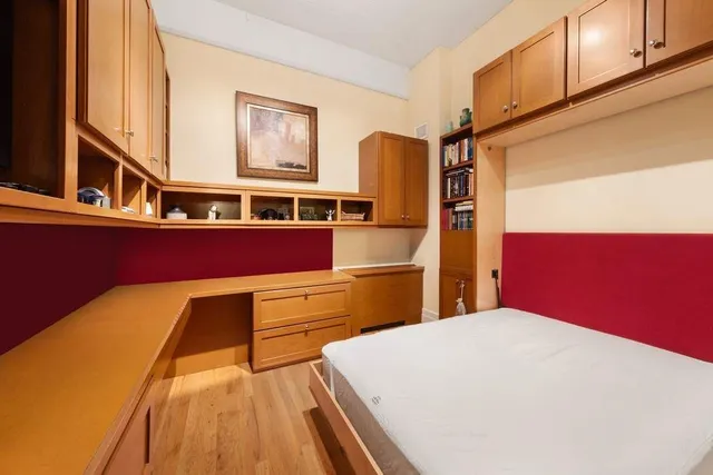 a kitchen with stainless steel appliances a refrigerator and wooden floor