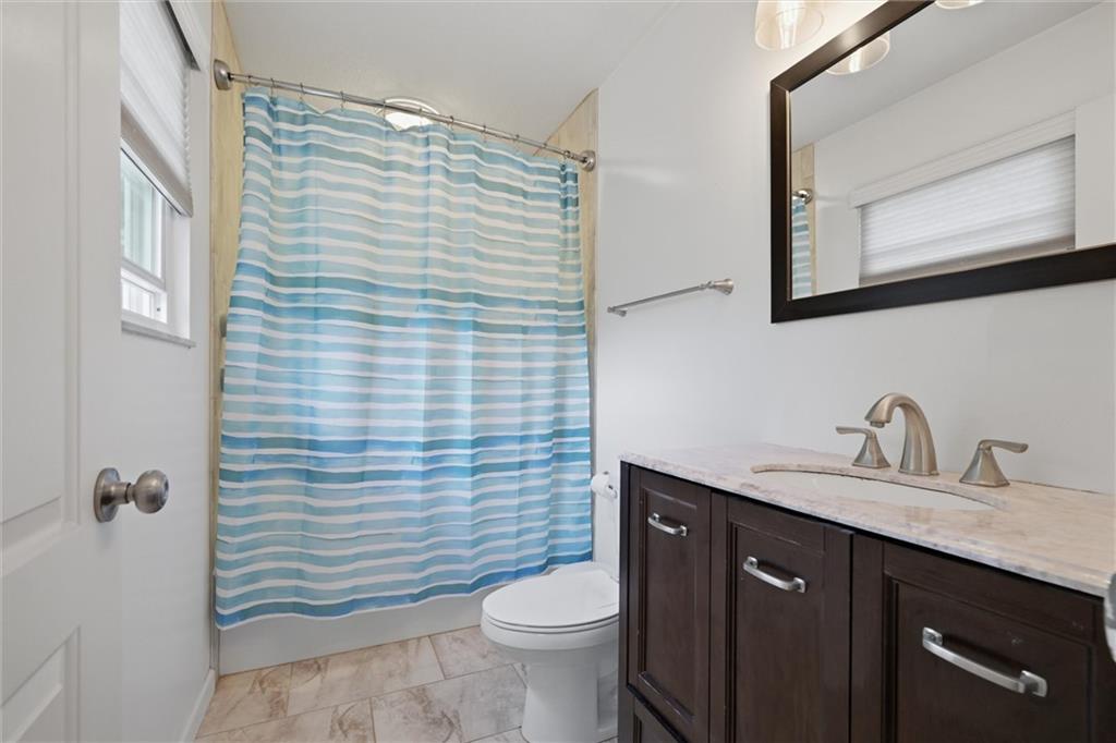 134 Stucky Road Renfrew, PA 16053 - Photo 15 of 32 a bathroom with a granite countertop toilet sink and mirror