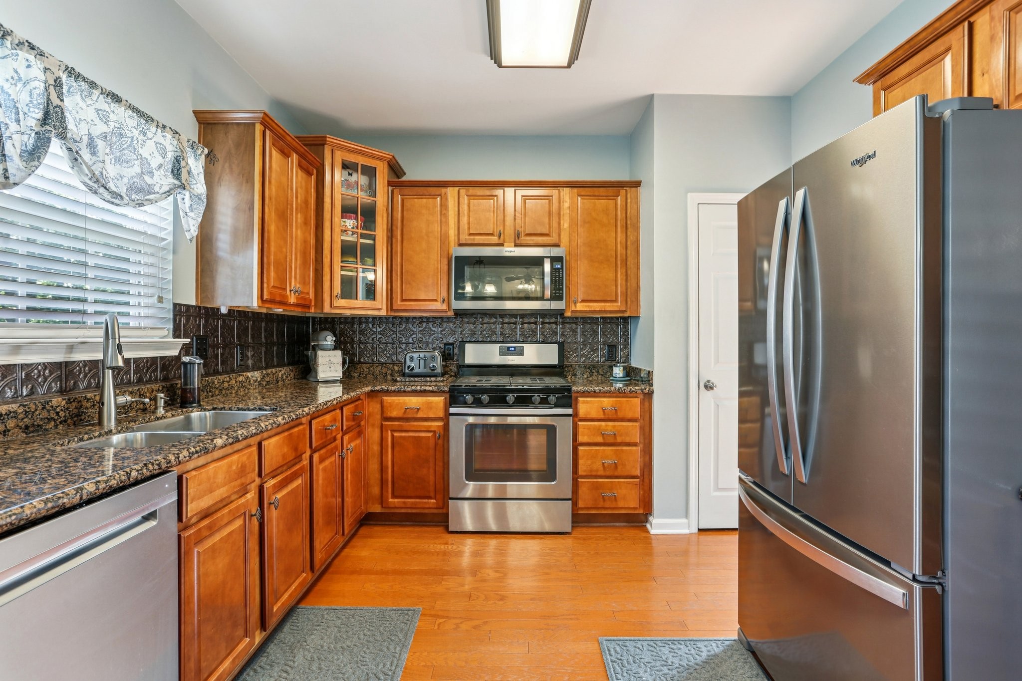 5017 Saunders Terrace Spring Hill, TN 37174 - Photo 13 of 52 a kitchen with stainless steel appliances granite countertop a refrigerator a stove and a sink