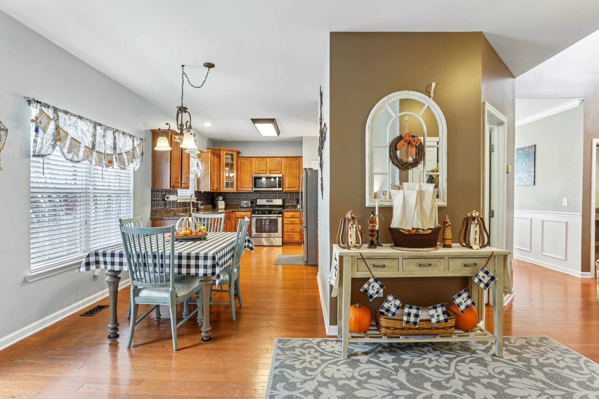 5017 Saunders Terrace Spring Hill, TN 37174 - Photo 19 of 52 a dining room with furniture a rug and wooden floor