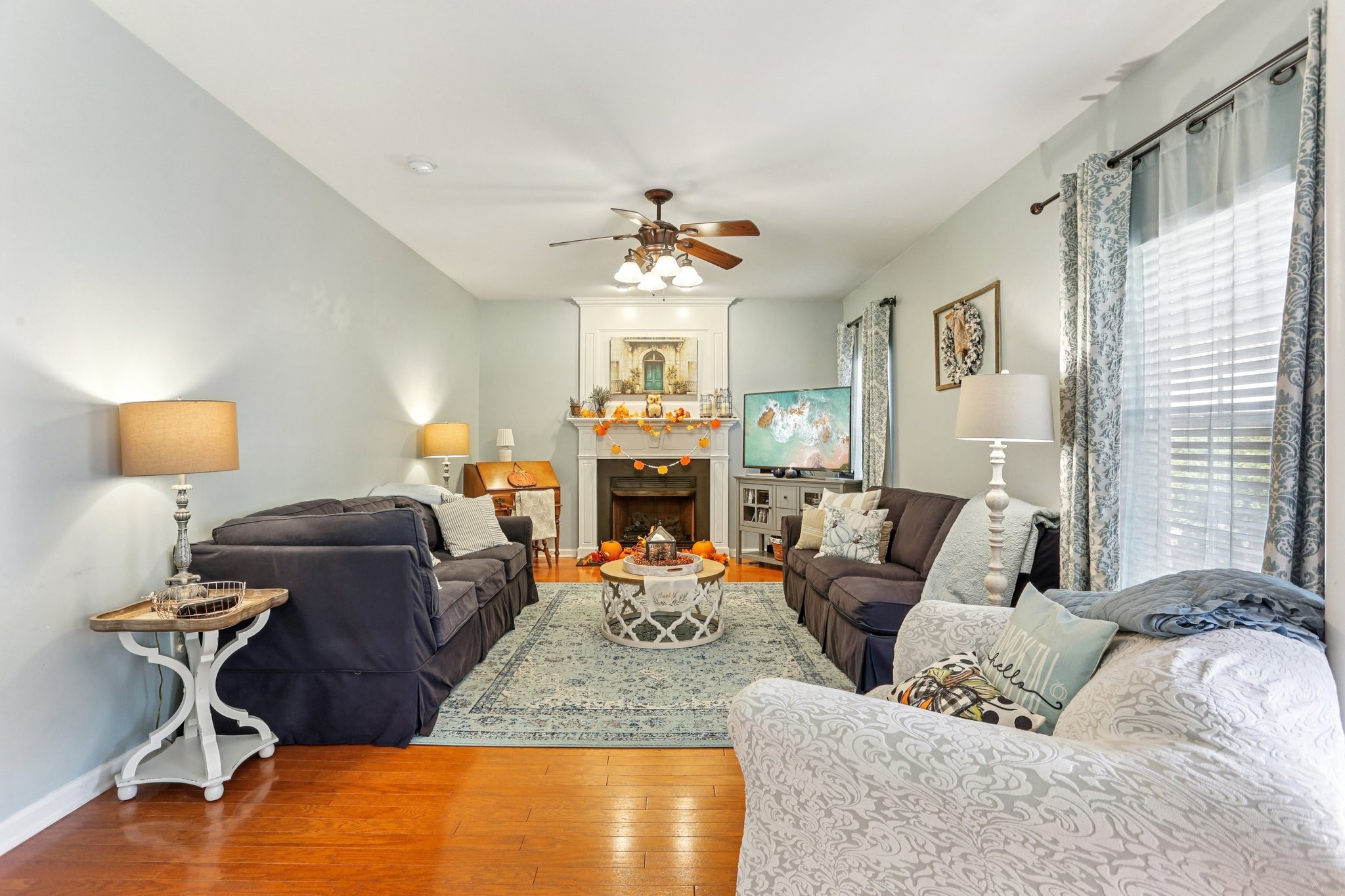 5017 Saunders Terrace Spring Hill, TN 37174 - Photo 20 of 52 a living room with furniture a fireplace and a chandelier