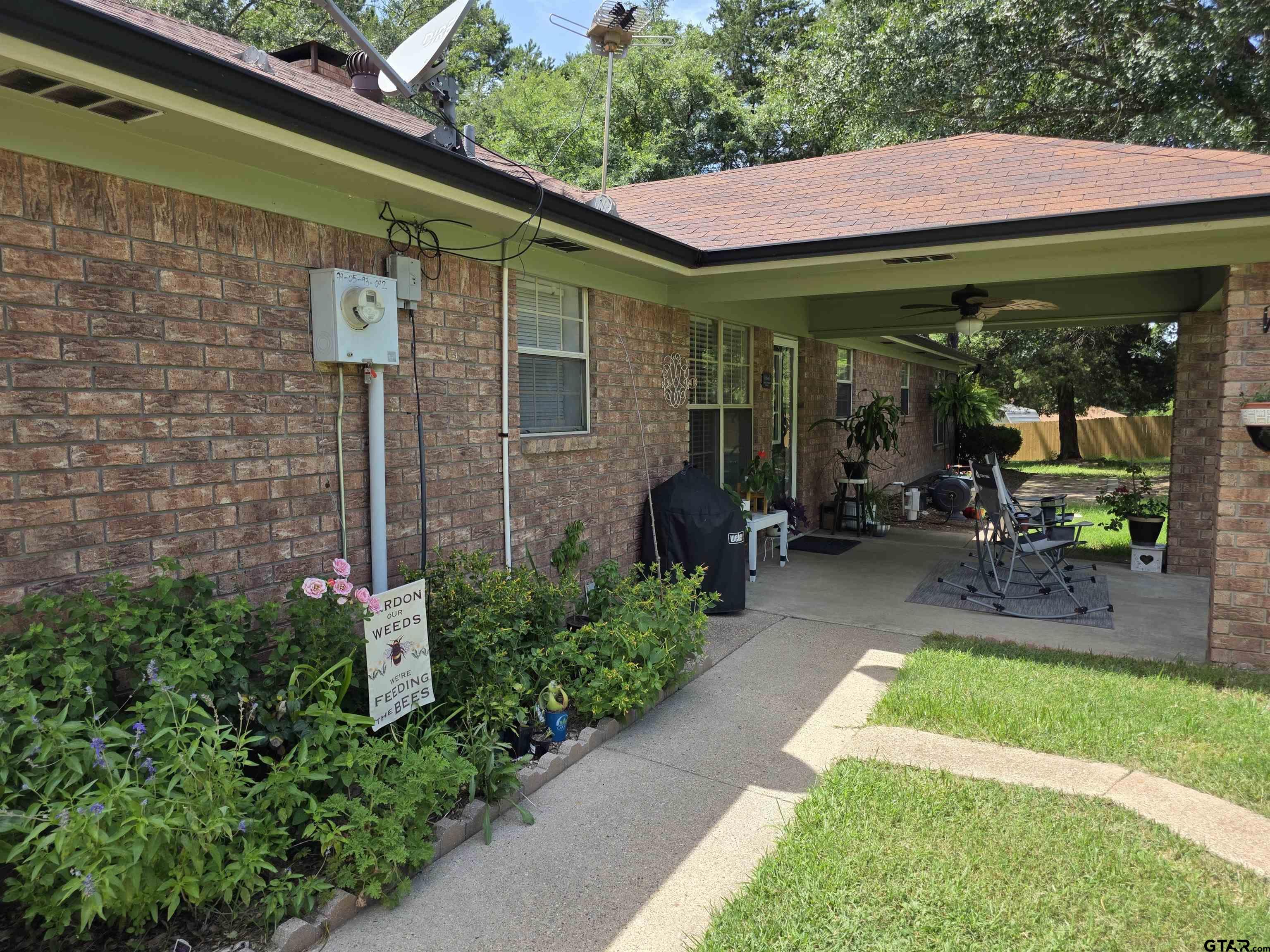 6170 Highway 271 Mount Pleasant, TX 75455 - Photo 6 of 43 a view of brick house with potted plants and a table and chairs