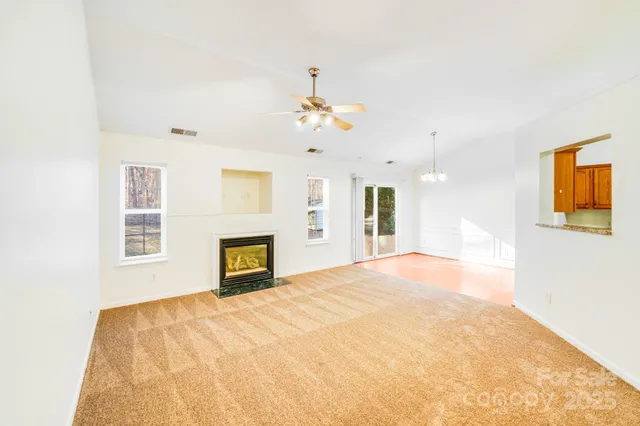 a view of a room with wooden floor and windows
