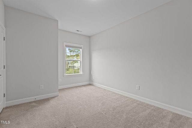 a bedroom with bed and a large window