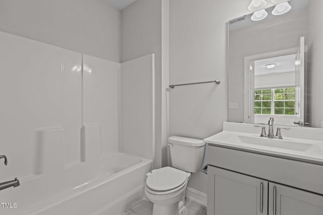 a bedroom with bed and a chandelier