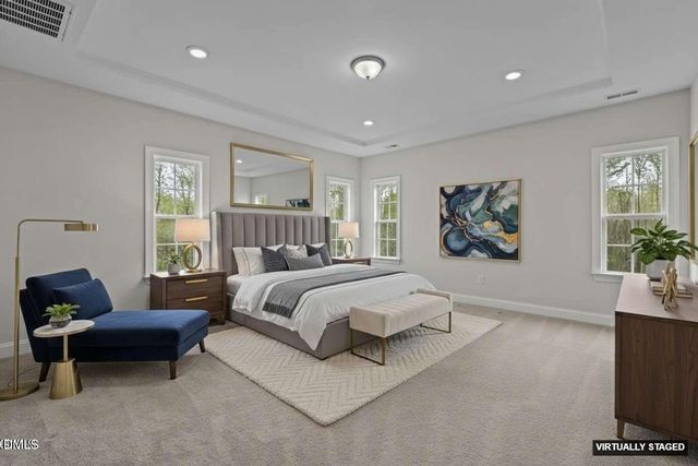 a living room with furniture and floor to ceiling window