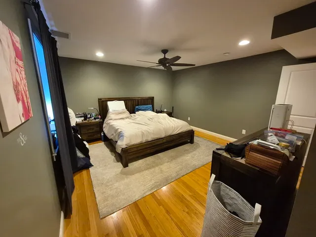 a bedroom with a bed and a mirror
