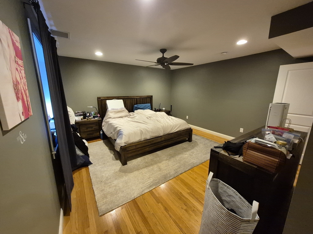 26 Dorr Street, Unit 26 Boston, MA 02119 - Photo 14 of 18 a bedroom with a bed and a mirror