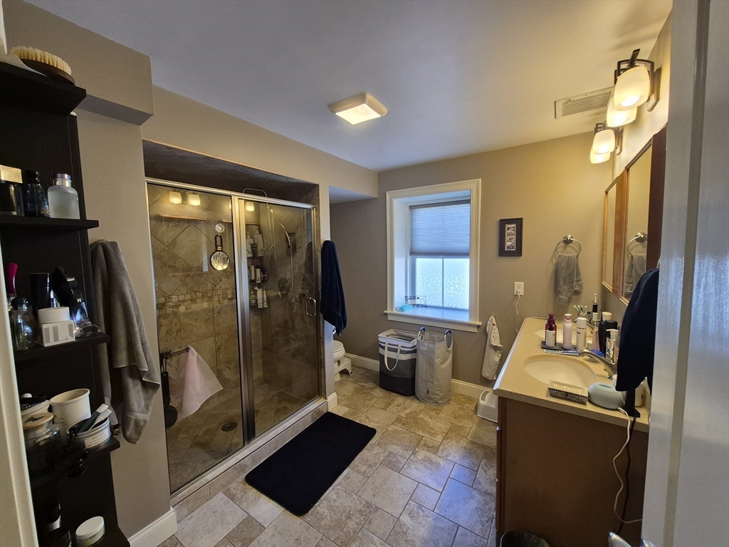 26 Dorr Street, Unit 26 Boston, MA 02119 - Photo 16 of 18 a room with gym equipment and a mirror