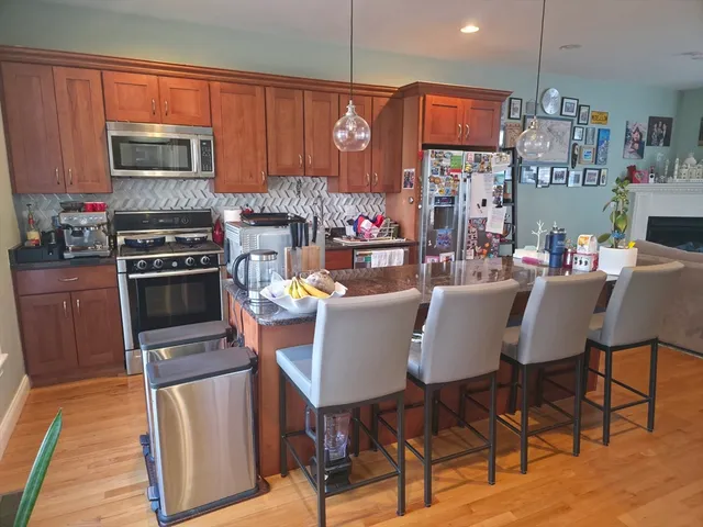 a kitchen with a dining table chairs and a kitchen view