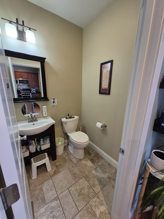 26 Dorr Street, Unit 26 Boston, MA 02119 - Photo 7 of 18 a bathroom with a toilet a sink and mirror