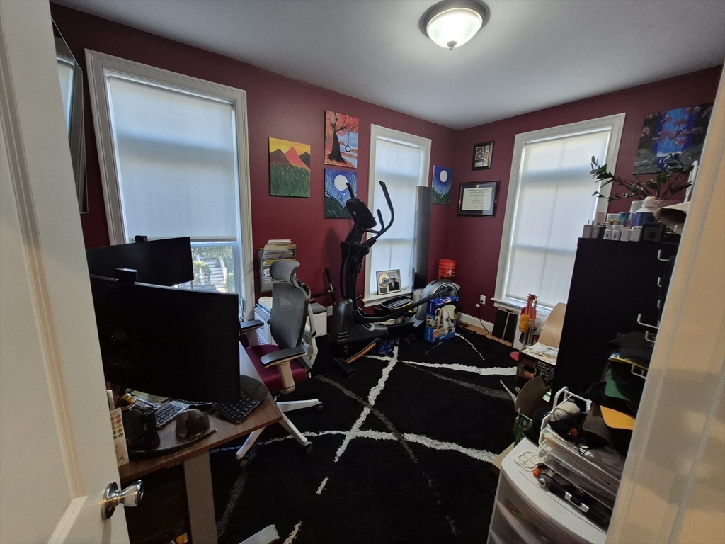 26 Dorr Street, Unit 26 Boston, MA 02119 - Photo 9 of 18 a room with furniture and musical instruments