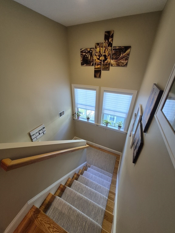 26 Dorr Street, Unit 26 Boston, MA 02119 - Photo 10 of 18 a view of a room with rack on the wall and stairs