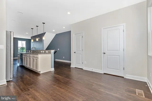 a view of kitchen with furniture and wooden floor