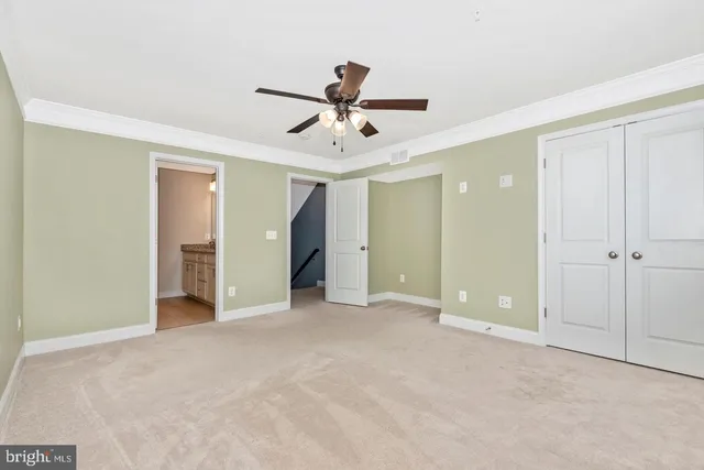 a view of empty room with ceiling fan