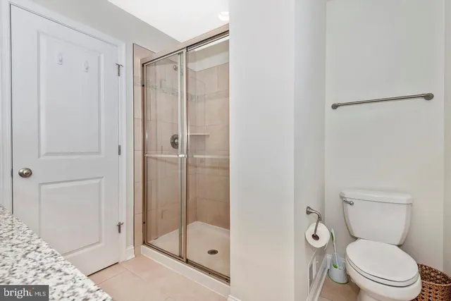 a bathroom with a shower a toilet and a sink