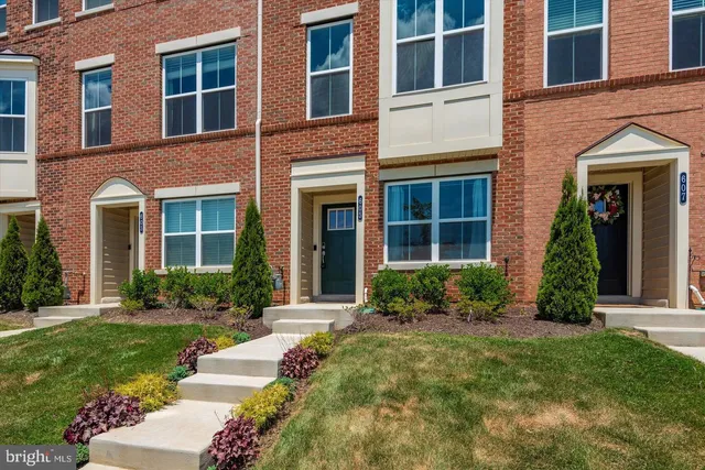 front view of a brick house with a yard
