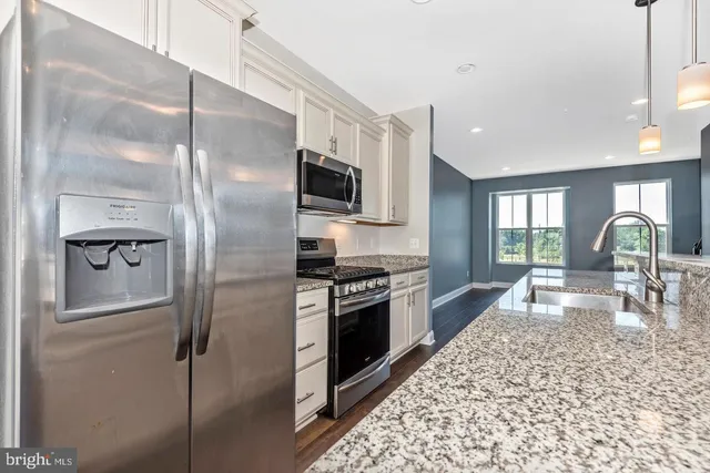a kitchen with a refrigerator stove and sink