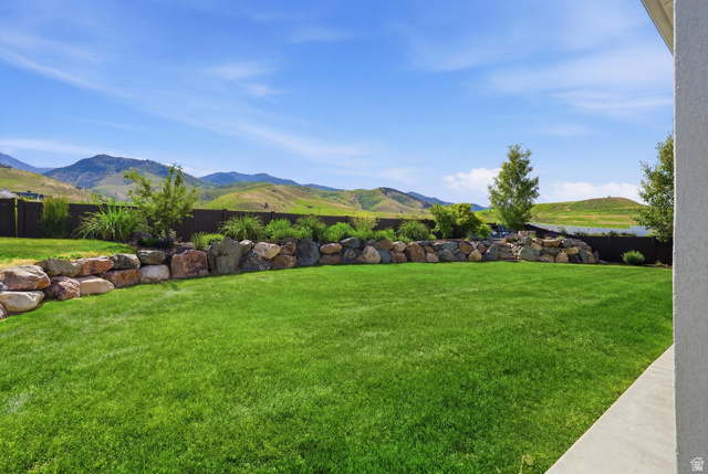 338 Windy Rdg Drive Smithfield, UT 84335 - Photo 56 of 63 Expansive green lawn with a rock retaining wall and mature landscaping