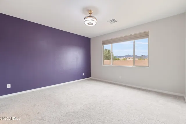 a spacious bathroom with a double vanity sink a large mirror and a shower