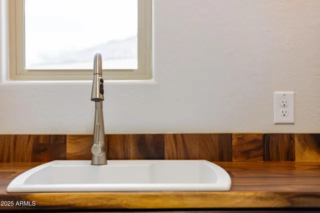 a view of a small space with wooden floor and a window