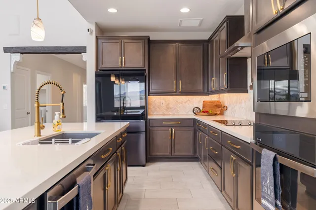a kitchen with granite countertop a sink and cabinets