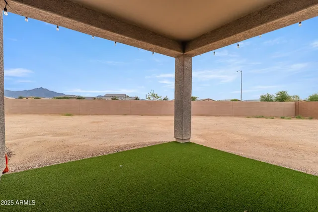 a front view of a house with a yard and mountain