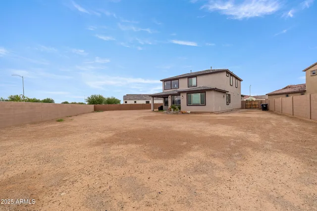 an aerial view of a house with garden space and a lake view