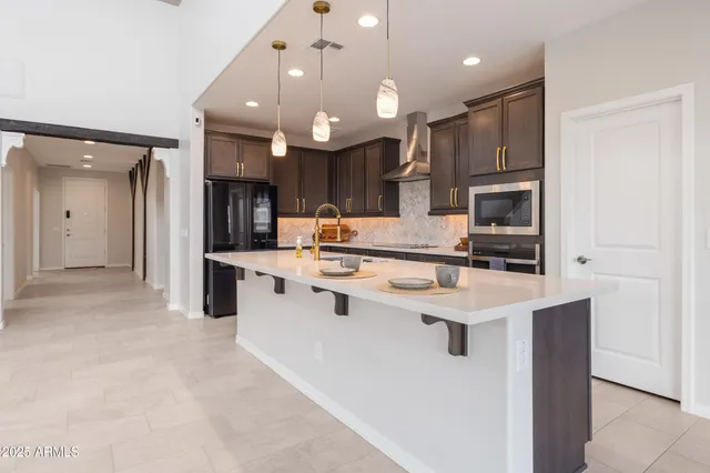 a kitchen with a sink a counter top stainless steel appliances and cabinets