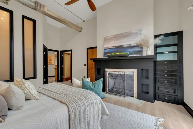 a bedroom with a bed and a fireplace