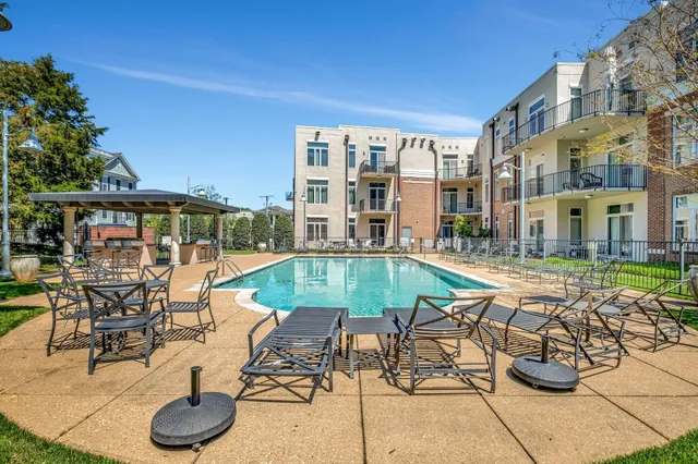 a view of a swimming pool with chairs and tables