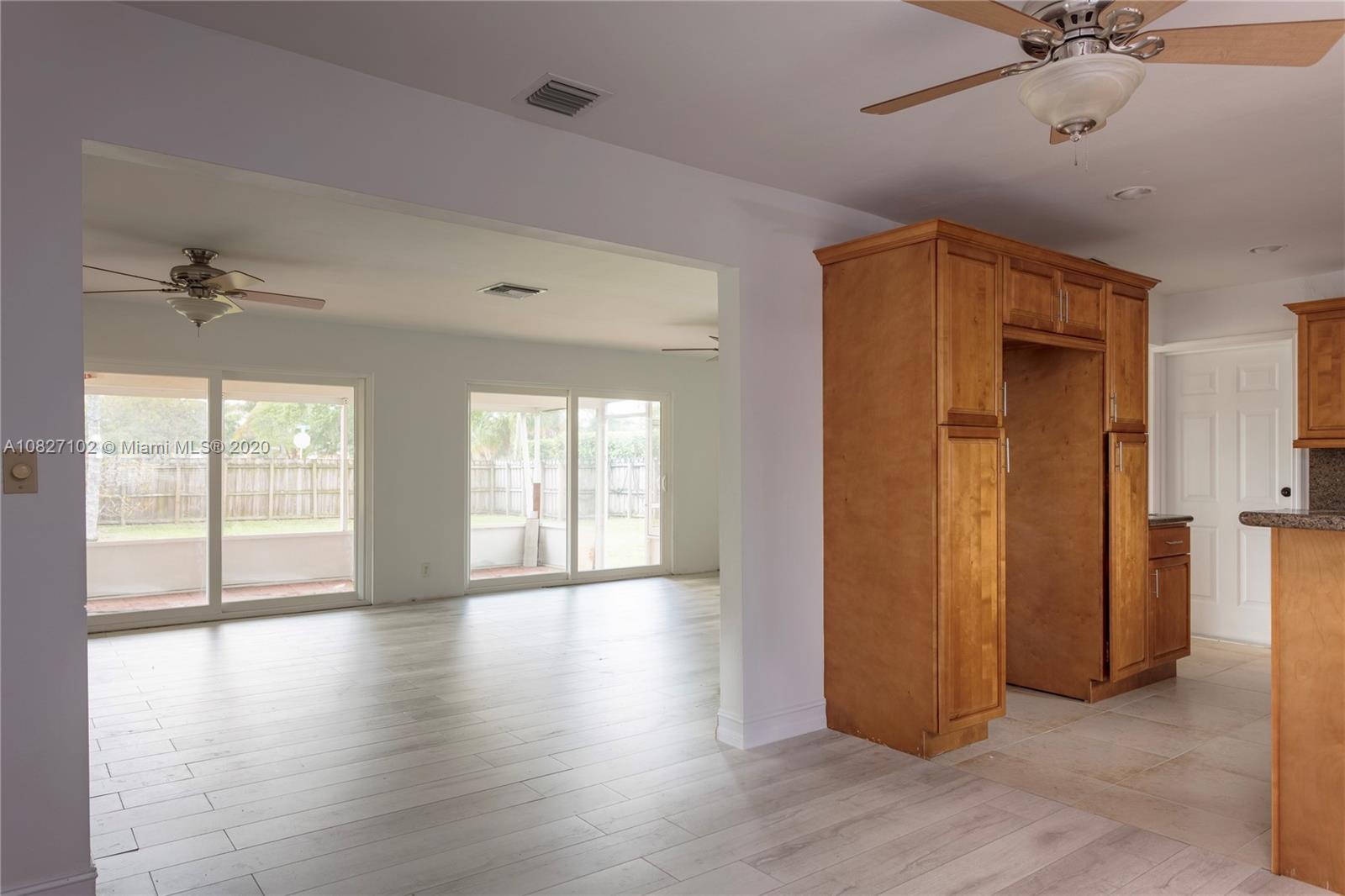3198 Arthur Terrace Hollywood, FL 33021 - Photo 3 of 18 a view of an empty room with a window and wooden floor