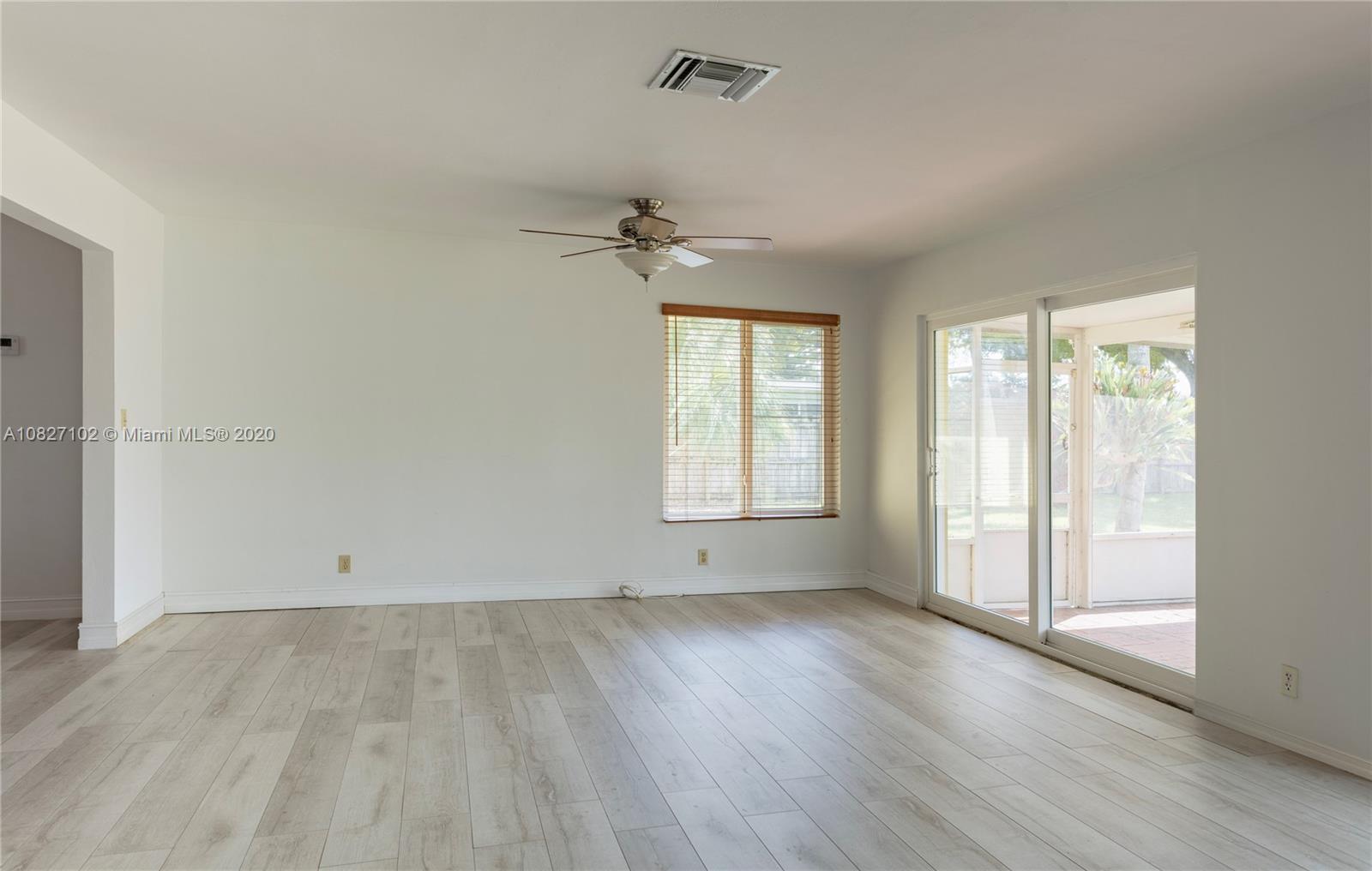3198 Arthur Terrace Hollywood, FL 33021 - Photo 4 of 18 an empty room with wooden floor and windows