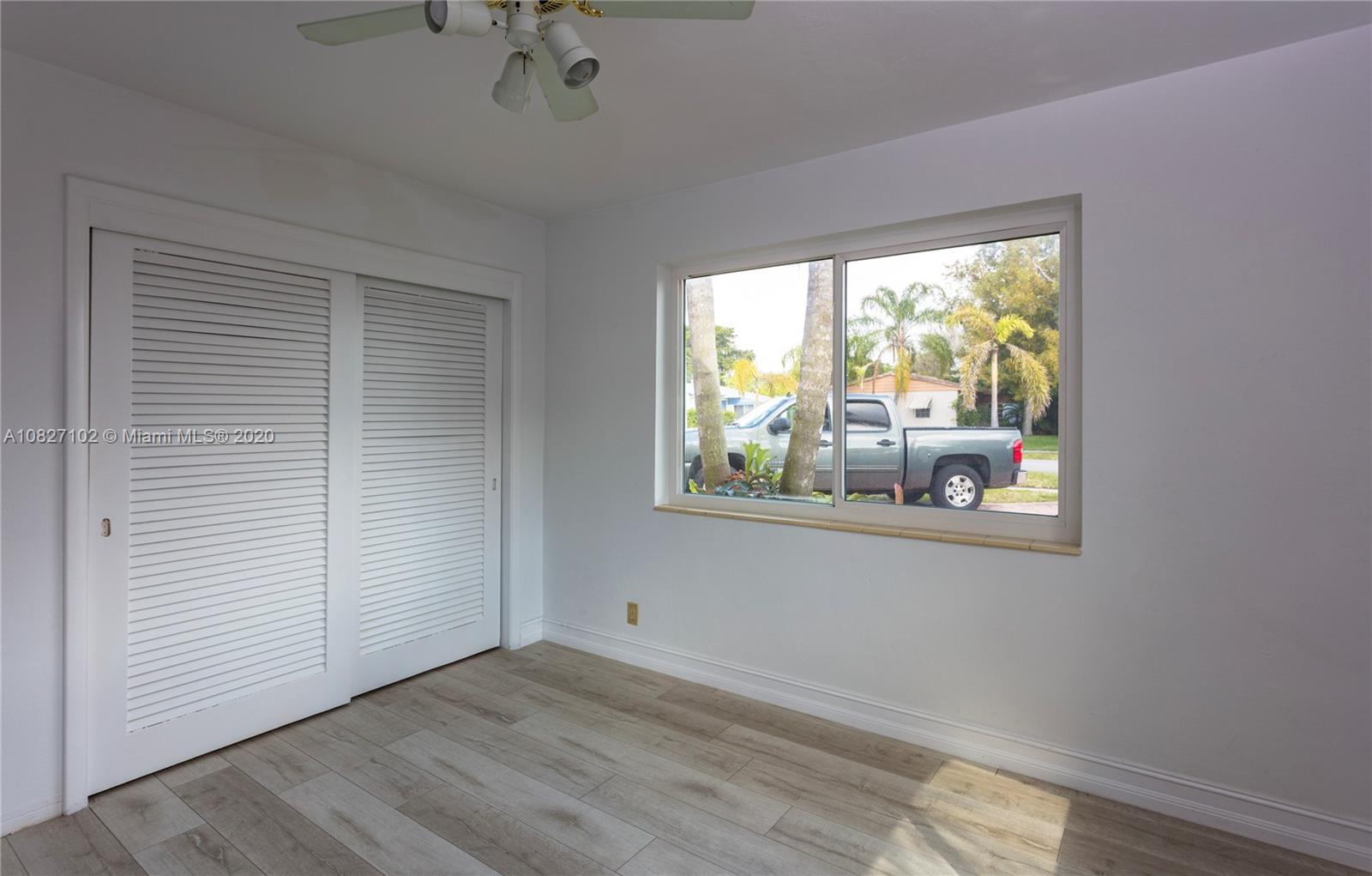 3198 Arthur Terrace Hollywood, FL 33021 - Photo 9 of 18 a view of an empty room with wooden floor and a window