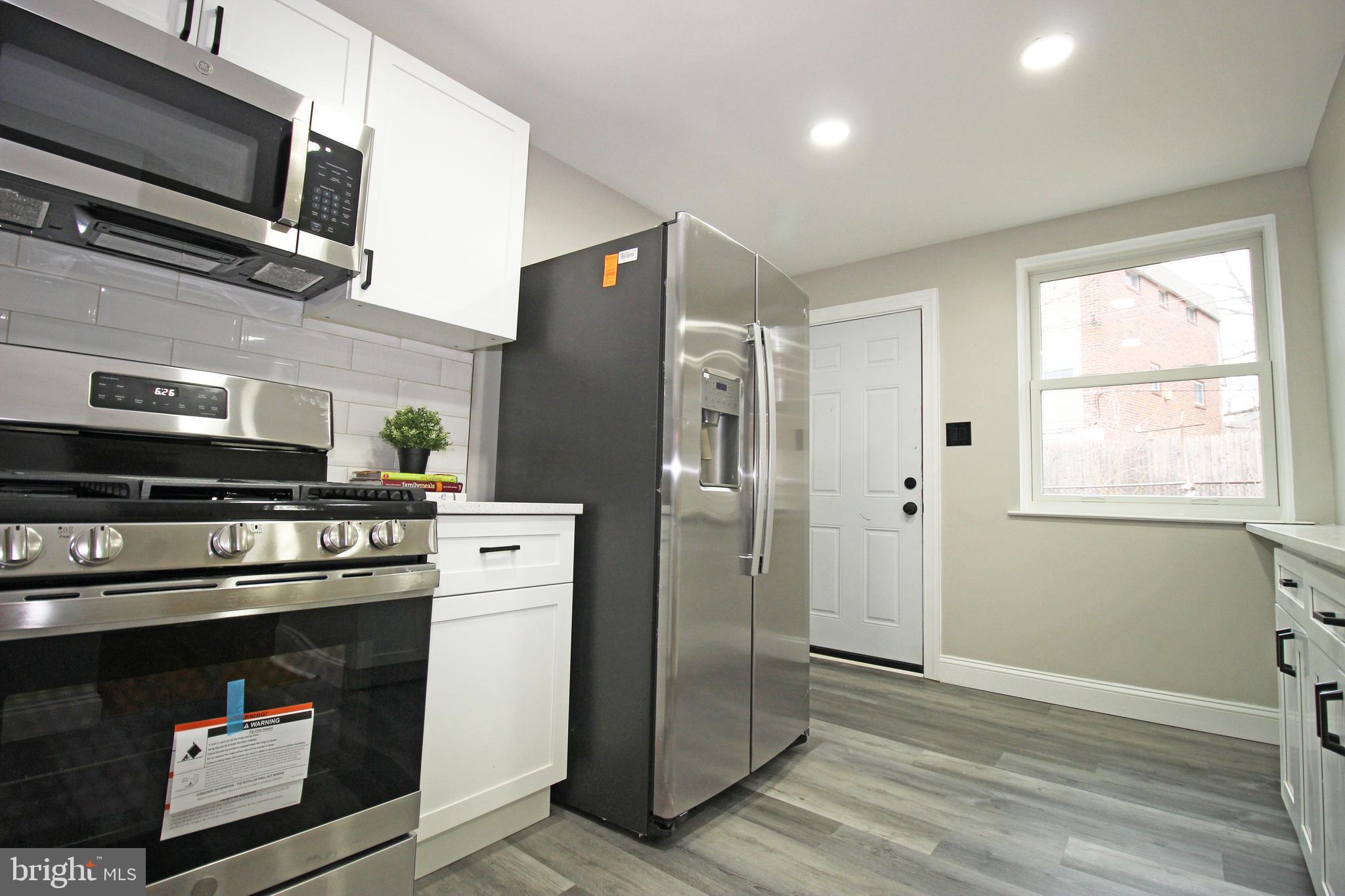 4017 Gideon Road Brookhaven, PA 19015 - Photo 27 of 54 a kitchen with a stove microwave and a refrigerator