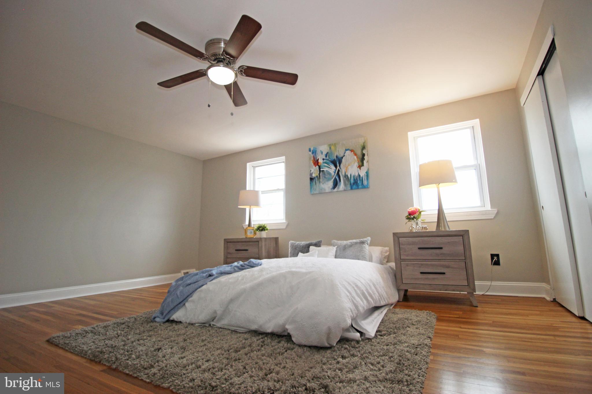 4017 Gideon Road Brookhaven, PA 19015 - Photo 32 of 54 a bedroom with a bed and wooden floor