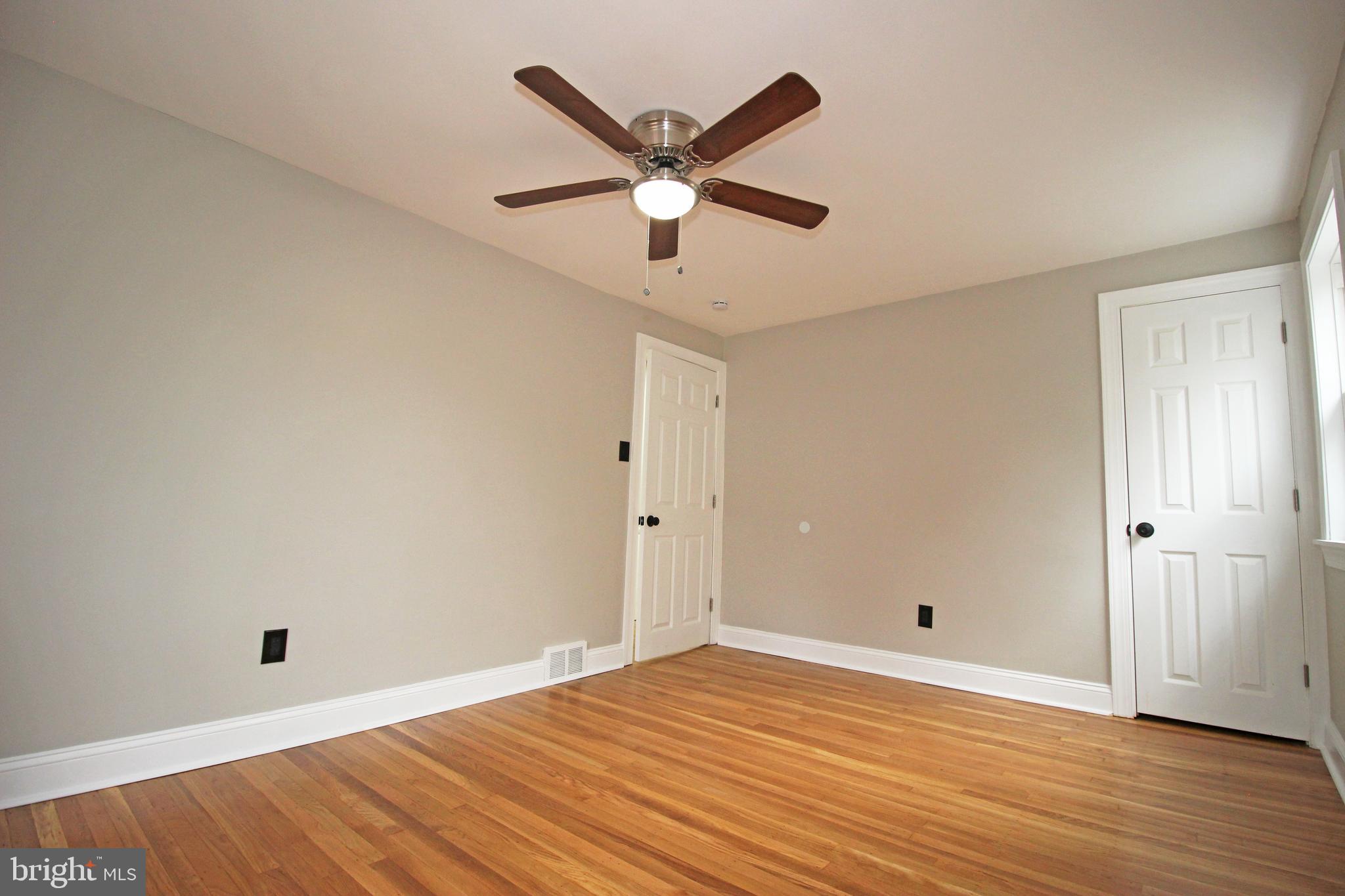 4017 Gideon Road Brookhaven, PA 19015 - Photo 38 of 54 an empty room with wooden floor and ceiling fan